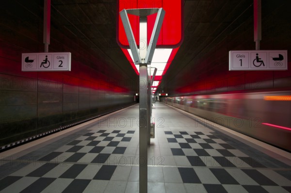HafenCity University underground station, illuminated in color, red, underground train, movement effect, U4, empty, platform, stop, train station, subway, sign, boarding area wheelchair user, stroller, public transport, HVV, Hamburger Verkehrsverbund, Hochbahn, public transport, Free and Hanseatic City of Hamburg, Germany