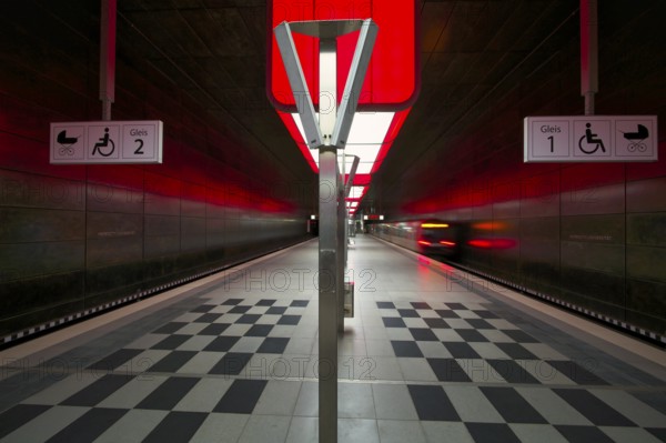 HafenCity University subway station, illuminated in color, red, underground train, movement effect, U4, empty, platform, stop, train station, subway, sign, boarding area wheelchair user, stroller, public transport, HVV, Hamburger Verkehrsverbund, Hochbahn, public transport, Free and Hanseatic City of Hamburg, Germany