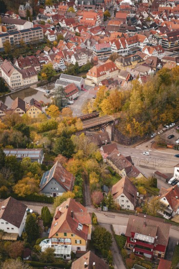 Bird's eye view of a residential area with numerous trees and houses in an autumnal atmosphere, Calw, Black Forest, Germany