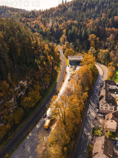 Aerial view of a winding road through an autumnal forest, Calw, Black Forest, Germany