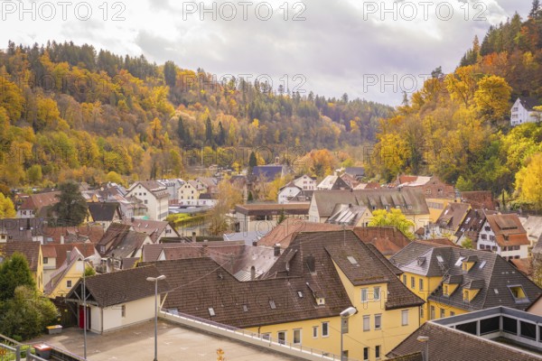 Urban autumn landscape with roofs and wooded hills, Calw, Black Forest, Germany