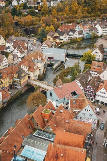 View of a historic old town with a river, half-timbered houses and a bridge in autumn, Calw, Black Forest, Germany