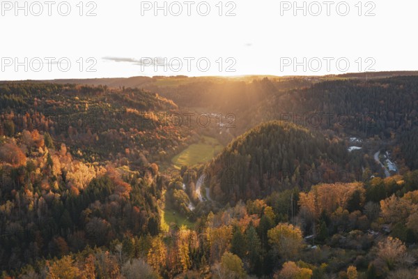 Wide view of an autumn forest and hills under a sunset sky, Calw, Black Forest, Germany