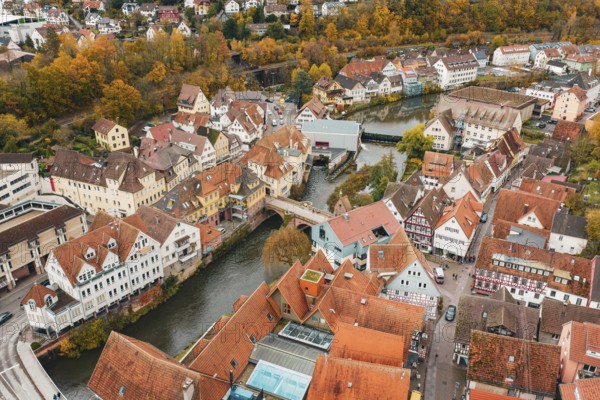 Historic old town with half-timbered houses and river views, surrounded by autumn trees, Calw, Black Forest, Germany