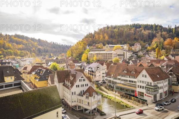 View of the city with autumn trees and hills in the background, Calw, Black Forest, Germany