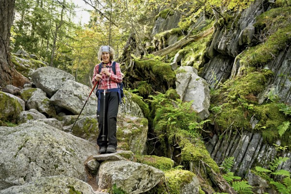 Female hiker on mountain tour standing in rocky terrain, Mont-Blanc, Chamonix-Mont-Blanc, Haute-Savoie, France
