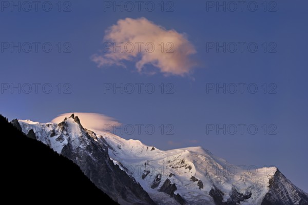 Aiguille du Midi snow-covered from left with sun-lit cloud over the summit, Mont-Blanc, Vallot Hut, Dome du Goûter, Aiguille du Goûter, Chamonix-Mont-Blanc, Haute-Savoie, France