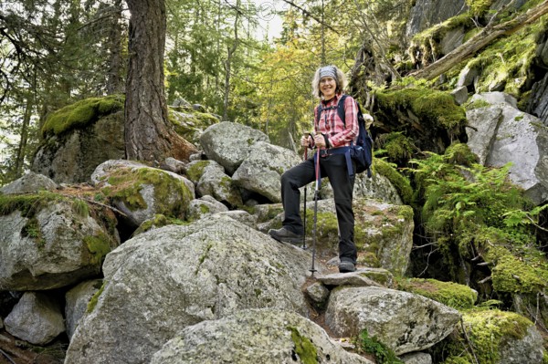 Female hiker on mountain tour standing in rocky terrain, Mont-Blanc, Chamonix-Mont-Blanc, Haute-Savoie, France