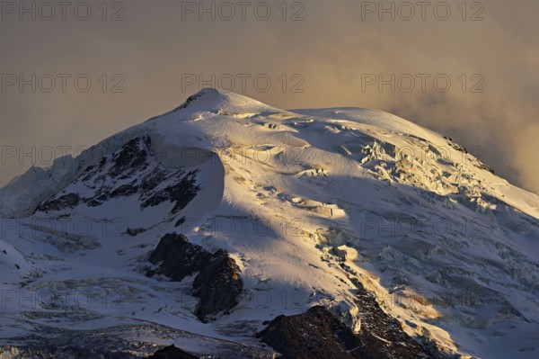 Snow-covered Dome du Goûter, in the evening light, Chamonix-Mont-Blanc, Haute-Savoie, France