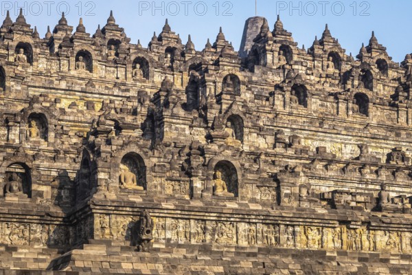 The historic Borobudur temple with its detailed reliefs in Indonesia during daylight, Indonesia