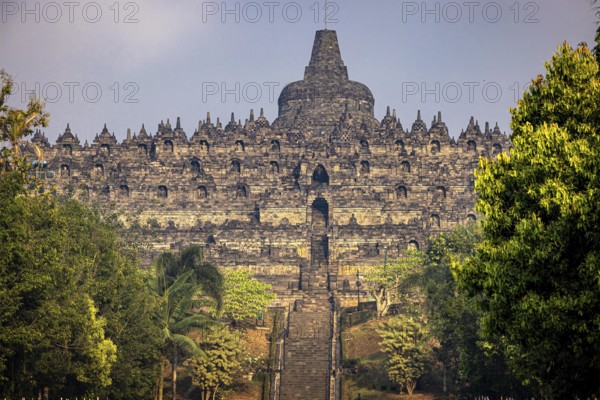 The impressive Borobudur Temple nestled in green surroundings in Indonesia