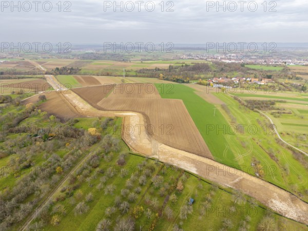 Aerial view of a rural region with fields and a faraway town, construction site, the South German Natural Gas Pipeline (SEL) is being built in the Rems Valley and the surrounding area, which will initially transport natural gas and later hydrogen, Waiblingen-Neustadt, Hohenacker, Baden-Württemberg, Germany