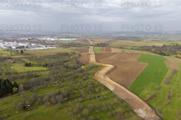 Aerial view of a rural area with fields and a city in the background under cloudy sky, construction site, the South German Natural Gas Pipeline (SEL) is being built in the Rems Valley and the surrounding area, which will initially transport natural gas and later hydrogen, Waiblingen-Neustadt, Hohenacker, Baden-Württemberg, Germany