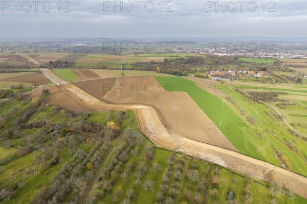 Extensive rural landscape with fields and power lines under a cloudy sky, construction site, the South German Natural Gas Pipeline (SEL) is being built in the Rems Valley and the surrounding area, which will initially transport natural gas and later hydrogen, Waiblingen-Neustadt, Hohenacker, Baden-Württemberg, Germany