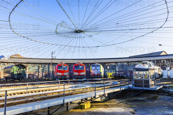 Turntable and overhead line spider, behind it modern locomotives of the Austrian Federal Railways, ÖBB, and Deutsche Bahn, DB, parked in front of the old lock shed, Augsburg railway park, administrative district of Swabia, Bavaria, Germany