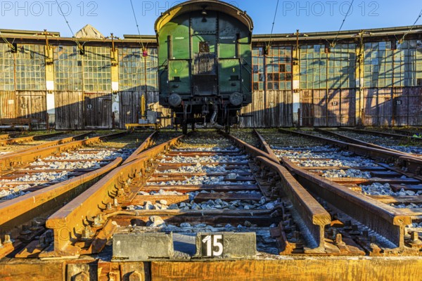 Historic railroad car parked in front of the old engine shed, Augsburg railway park, administrative district of Swabia, Bavaria, Germany