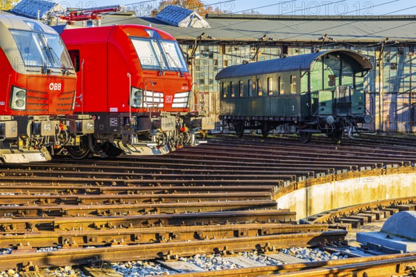 Modern locomotives of the Austrian Federal Railways, ÖBB, and Deutsche Bahn, DB, historic railroad car, parked in front of the old lock shed, Augsburg railway park, administrative district of Swabia, Bavaria, Germany