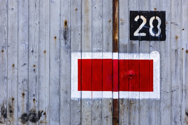 Protection signal with red and white paint at entrance gate No. 28 to the old engine shed, Augsburg railway park, administrative district of Swabia, Bavaria, Germany