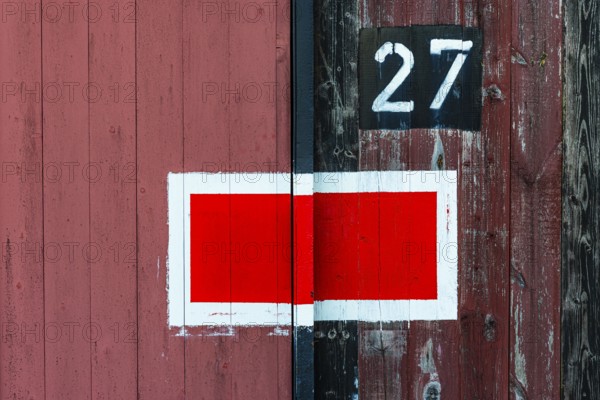Protection signal with red and white paint at entrance gate no. 27 to the old engine shed, Augsburg railway park, administrative district of Swabia, Bavaria, Germany