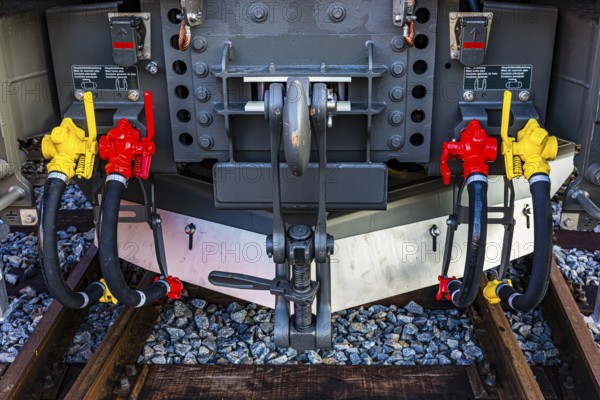 Yellow and red levers for main air lines on a modern railway locomotive, Augsburg railway park, administrative district of Swabia, Bavaria, Germany