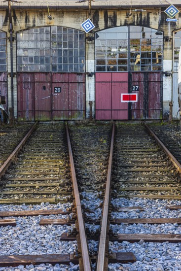 The entrance gates 26 and 27 and railroad tracks of the old engine shed, Augsburg railway park, administrative district of Swabia, Bavaria, Germany