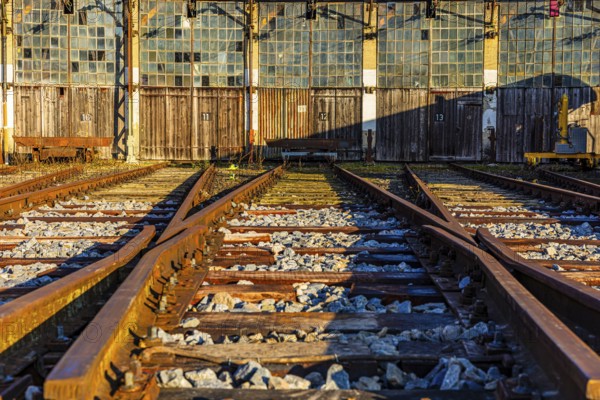 Railroad tracks lead to the entrance gates at the old engine shed, Augsburg railway park, administrative district of Swabia, Bavaria, Germany