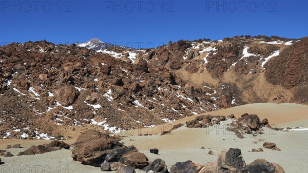 Barren volcanic landscape with rocks and snow trails under clear sky, UNESCO World Heritage Site, Teide National Park, Teide National Park, Tenerife, Canary Islands, Spain