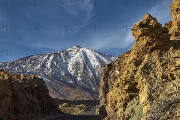 Snow-covered Teide, snowy mountain with road between majestic rocks in clear skies, UNESCO World Heritage Site, Teide National Park, Teide National Park, Tenerife, Canary Islands, Spain
