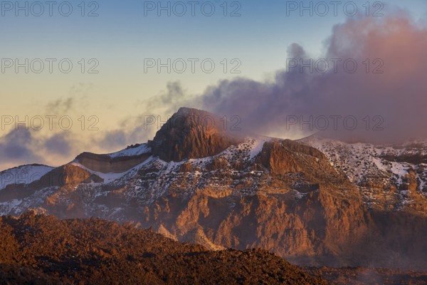 Rugged mountain landscape in the light of the setting sun, surrounded by clouds, UNESCO World Heritage Site, Teide National Park, Tenerife, Canary Islands, Spain