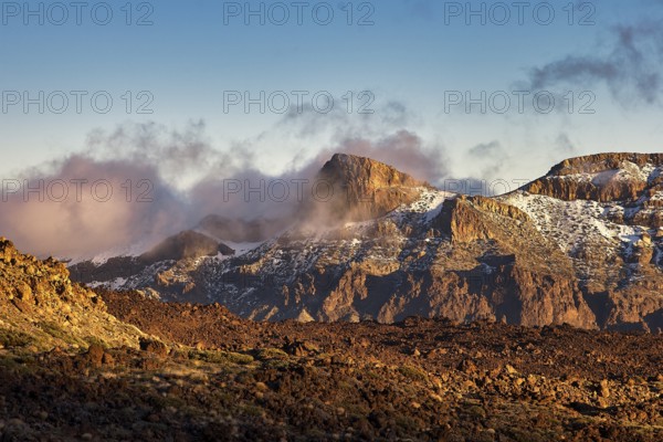 Steep mountains in the evening light with fog and clouds that create a mystical atmosphere, UNESCO World Heritage Site, Teide National Park, Tenerife, Canary Islands, Spain