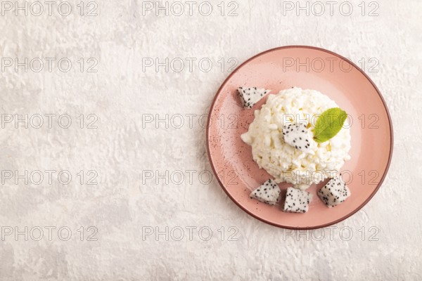 White ?ottage cheese, Curd, with Pithaya on gray concrete background, top view, flat lay, copy space