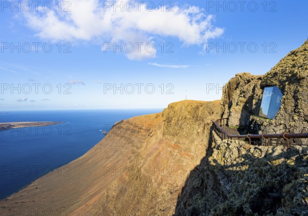 Panoramic window at the Mirador del Río viewpoint, designed by artist César Manrique, view of steep cliffs and sea in the evening light, Lanzarote, Canary Islands, Spain