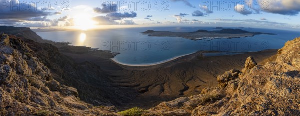 View of steep cliffs to sea and the island of La Graciosa, Mirador del Porrito viewpoint at sunset, Lanzarote, Canary Islands, Spain
