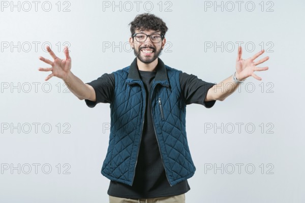 Friendly guy welcoming with open arms isolated. Cheerful young man welcoming you with open arms