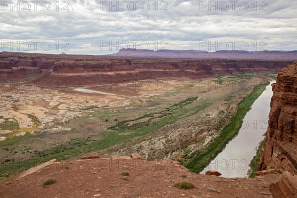 Hite, Michigan - Lake Powell has disappeared from the former Hite Marina, where boats used to launch from the concrete slab at center left. A long-term drought in the Colorado River basin has dropped Lake Powell to its lowest level since 1969. The Colorado now flows thousands of feet from the launch ramp