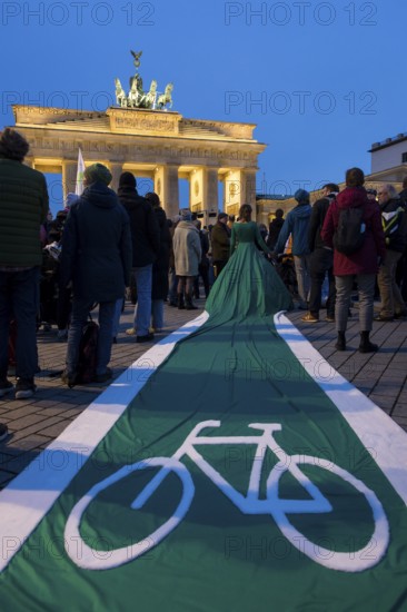 Athena Macke (costume designer) wears a dress with a long train in the shape of a bike path (bike path dress) at the international climate demo under the motto Fight for 1.5 at the Brandenburg Gate in Berlin on 14.11.2025. The demonstration takes place on the occasion of the COP30 World Climate Conference in Belém, Brazil, and to mark 10 years of the Paris Climate Agreement