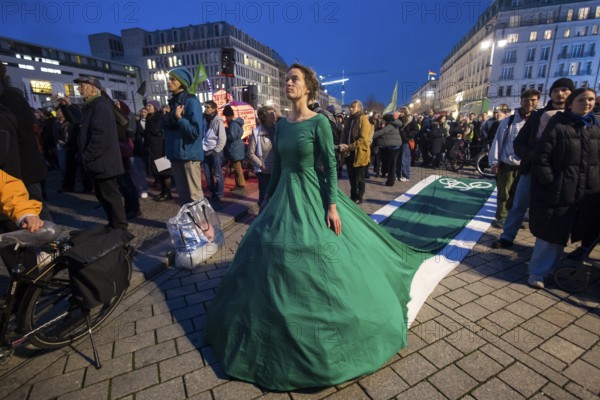 Athena Macke (costume designer) wears a dress with a long train in the shape of a bike path (bike path dress) at the international climate demo under the motto Fight for 1.5 at the Brandenburg Gate in Berlin on 14.11.2025. The demonstration takes place on the occasion of the COP30 World Climate Conference in Belém, Brazil, and to mark 10 years of the Paris Climate Agreement