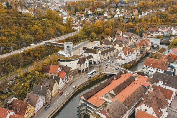 Aerial view of an urban environment with tower, roads and autumn landscape, Hermann Hessebahn, ZOB Calw, Germany