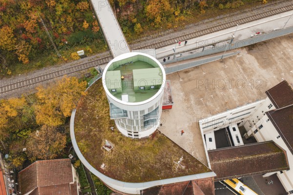 Tower with balcony and parking area, surrounded by autumn leaves and railroad tracks, Hermann Hessebahn, ZOB Calw, Germany