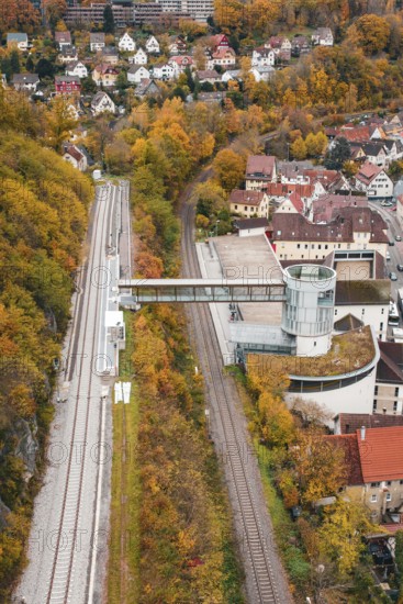 View of railroad, tower and municipal buildings surrounded by autumn colors, Hermann Hessebahn, ZOB Calw, Germany