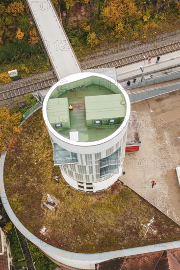 Detailed view of a tower with a green roof and walkers, Hermann Hessebahn, ZOB Calw, Germany