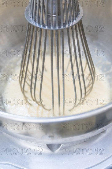 A metal whisk mixes a white mass in a metal bowl, Christmas baking, Haselstaller Hof, Wildberg, Germany