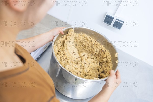 Person holding large bowl of dough in kitchen, preparing for baking, Christmas baking, Haselstaller Hof, Wildberg, Germany