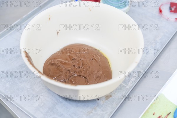 A white bowl of melted chocolate on a preparation table, Christmas baking, Haselstaller Hof, Wildberg, Germany
