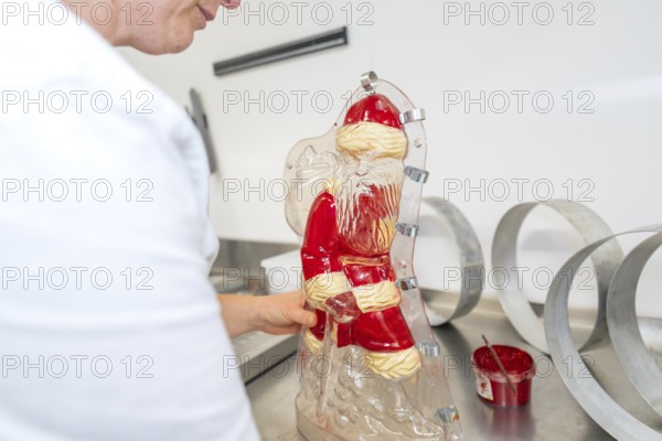 Chocolate Santa Claus mold is worked on a table, Christmas baking, Haselstaller Hof, Wildberg, Germany