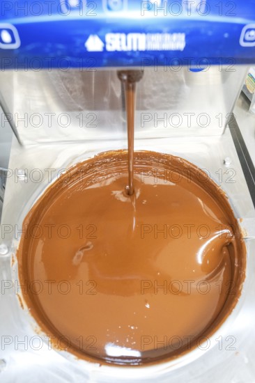 Close-up of liquid chocolate flowing from a machine, Christmas baking, Haselstaller Hof, Wildberg, Germany
