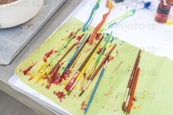 Colourful brushes and toothbrushes on a creatively designed table, Christmas baking, Haselstaller Hof, Wildberg, Germany