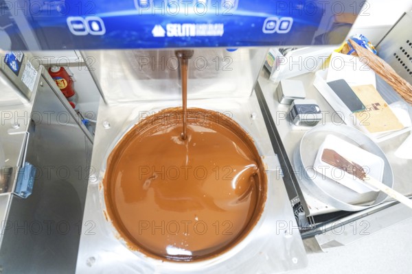 Chocolate machine with liquid chocolate in a commercial kitchen, Christmas baking, Haselstaller Hof, Wildberg, Germany