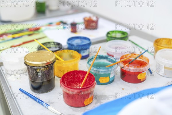 Colourful painting supplies on a table with coloured containers and brushes, Christmas baking, Haselstaller Hof, Wildberg, Germany