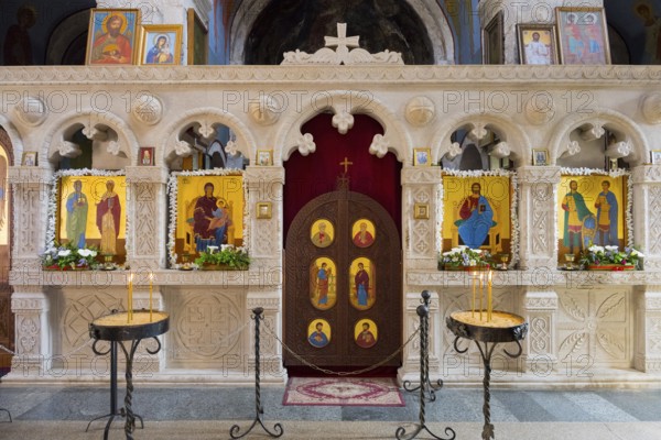 An altar decorated with icons in a church, candles shining in front of it, Motsameta monastery, near Kutaisi, Imereti region, Georgia
